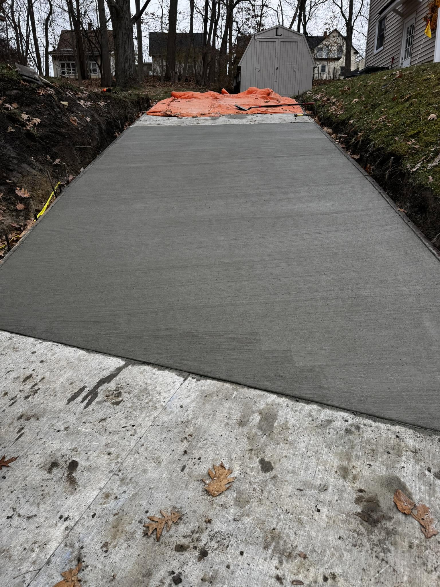 Newly poured concrete driveway with broom finish